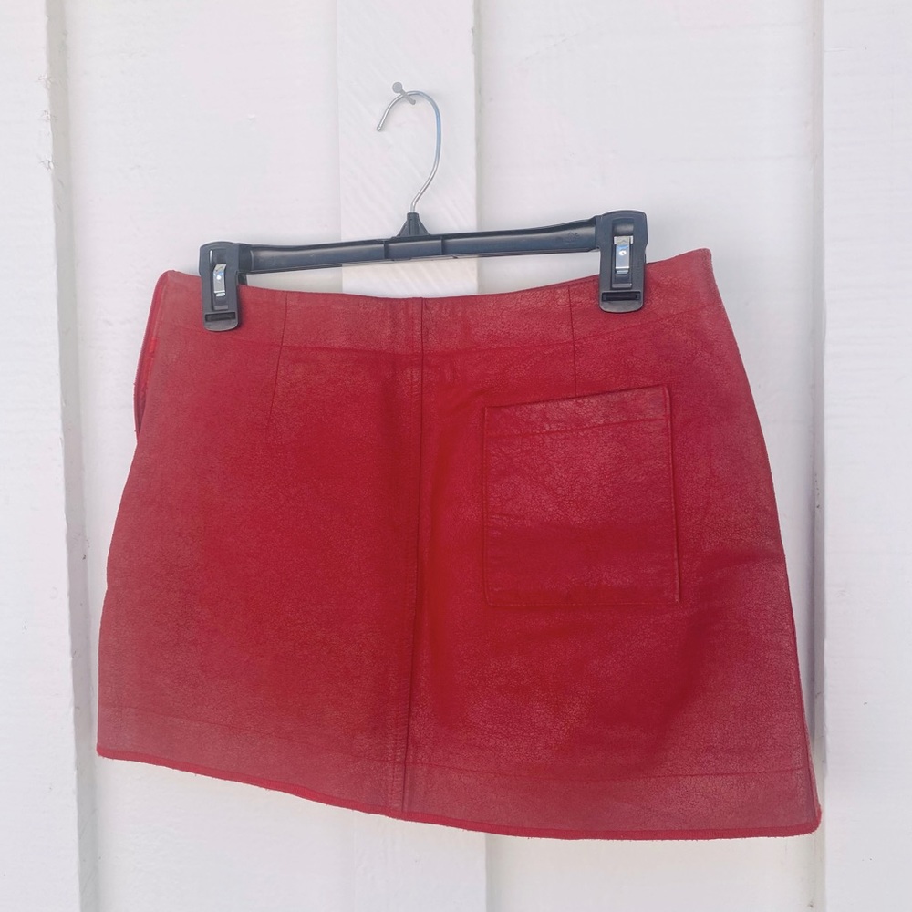 Vintage red leather BCBG miniskirt with side zipper and a back pocket.